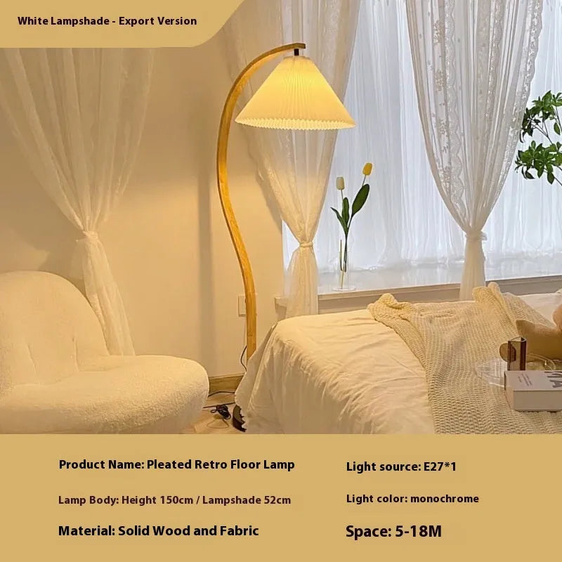 Retro vertical table lamp with tall stand and choice of log white or wine red shade on a bedside table.
