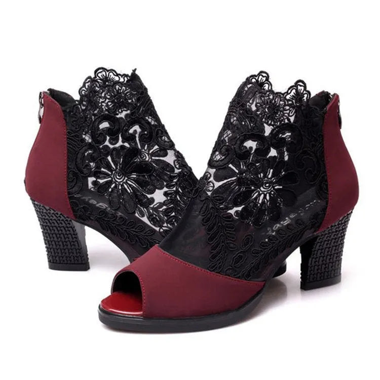 Black lace gladiator sandals for women with a square high heel and peep toe, showing zip closure.