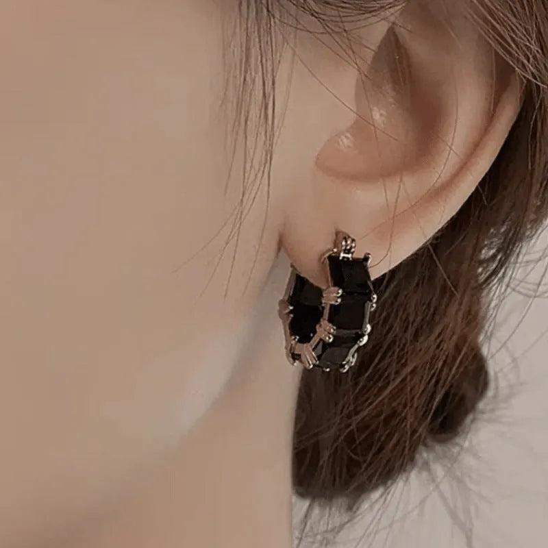 Geometric U-shaped gold electroplated copper ear rings with round black zircon settings