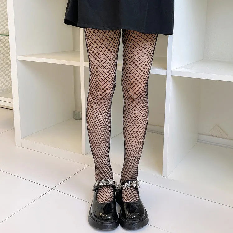 Women's black and white mesh stockings showing large, medium, and small net patterns on a leg.
