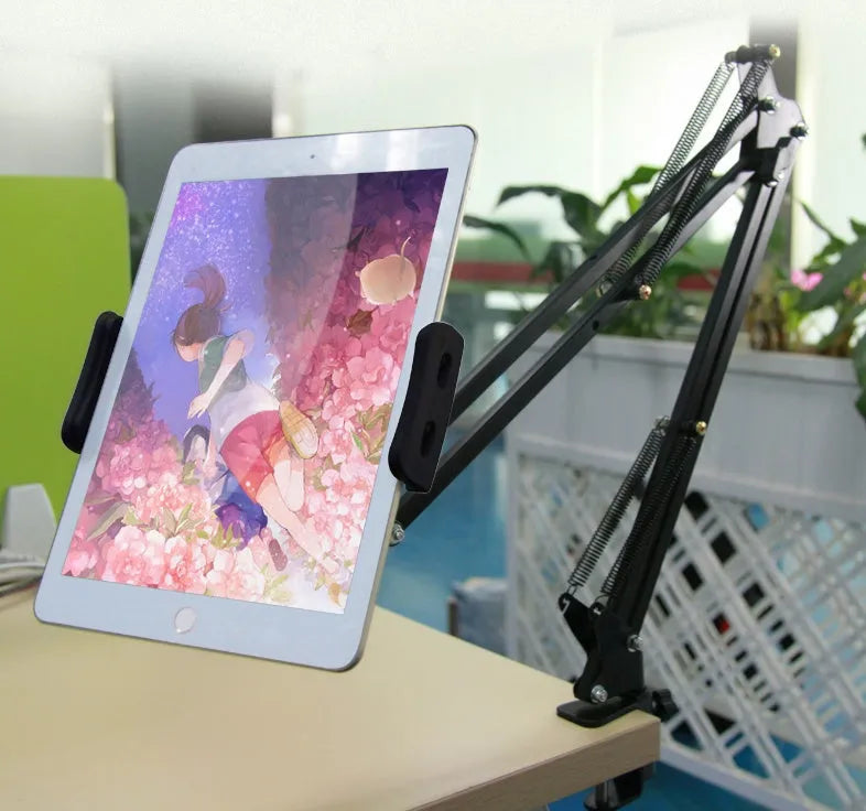 Black and white adjustable phone and tablet stand on a desk at 10cm height