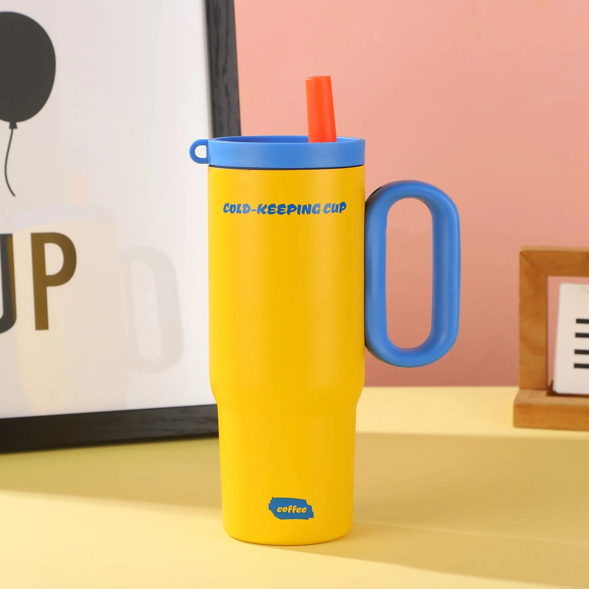 Large insulated straw drinking cup with a carrying handle in various colours.