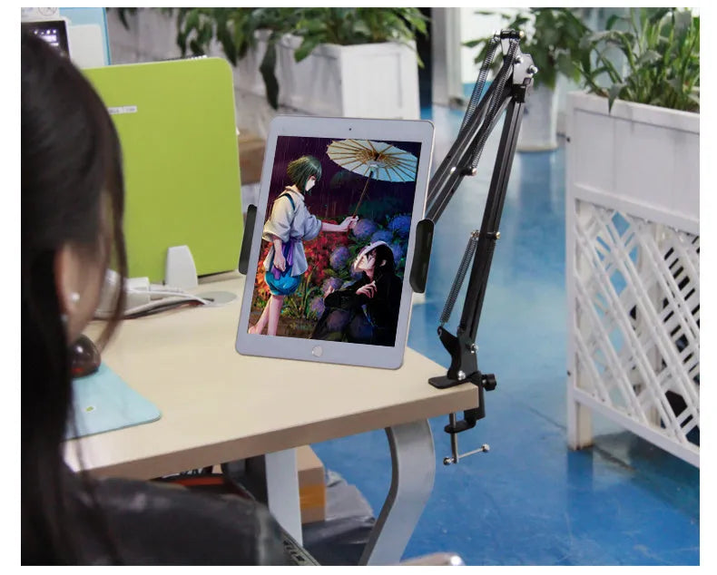 Black and white adjustable phone and tablet stand on a desk at 10cm height