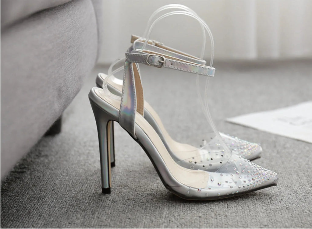 Women's clear PVC pointed toe sandals with a stiletto heel on a white background.