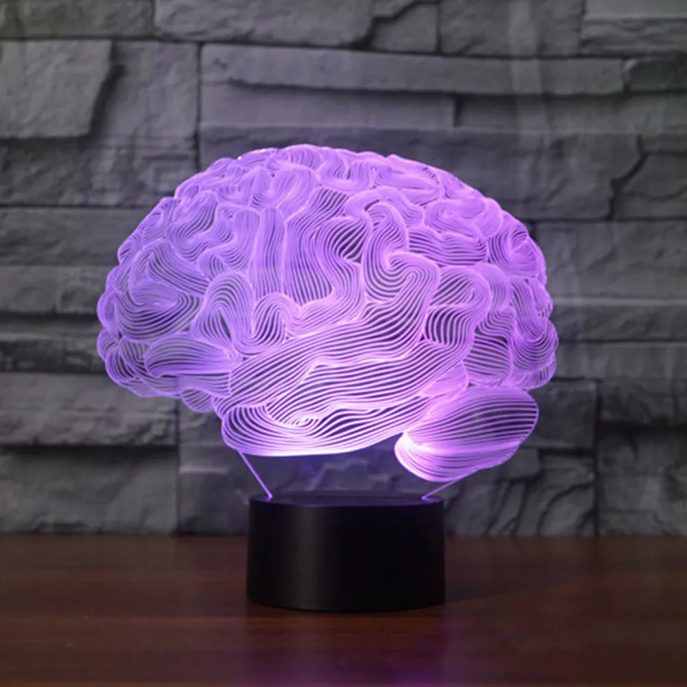 3D acrylic brain illusion LED desk lamp with remote control on a wooden table.