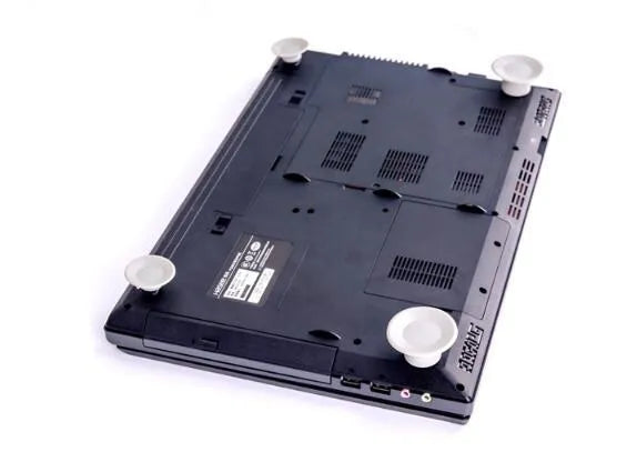 Four grey plastic laptop cooling pads: two large and two small, on a flat surface.