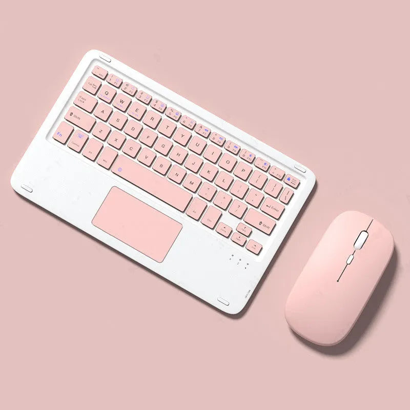 Pink wireless keyboard and mouse combo with slim touch keyboard and Bluetooth connectivity on wooden desk