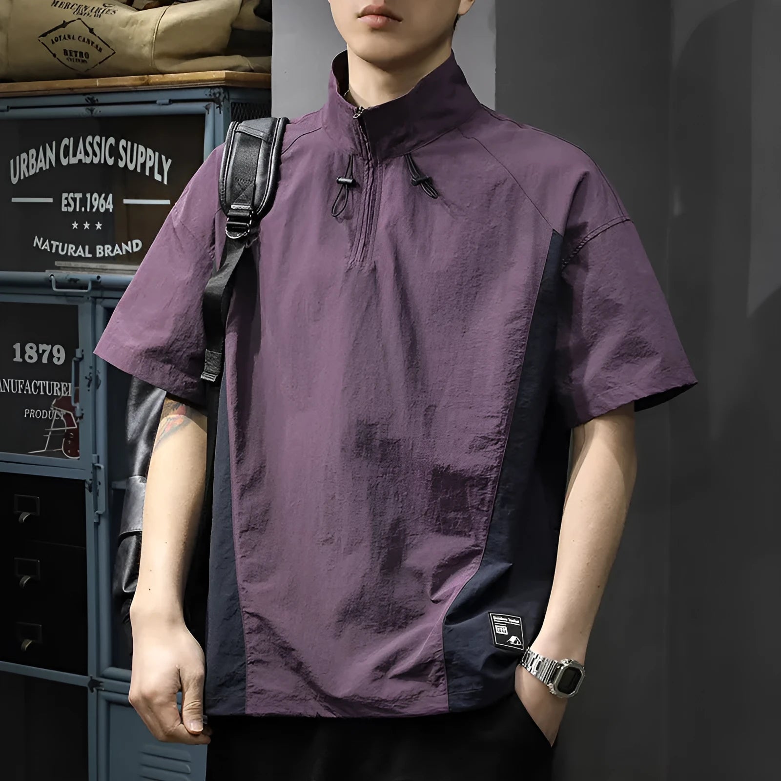 Brown men's half-zip stand collar short sleeve casual shirt laid flat, showing fleece lining and loose fit.