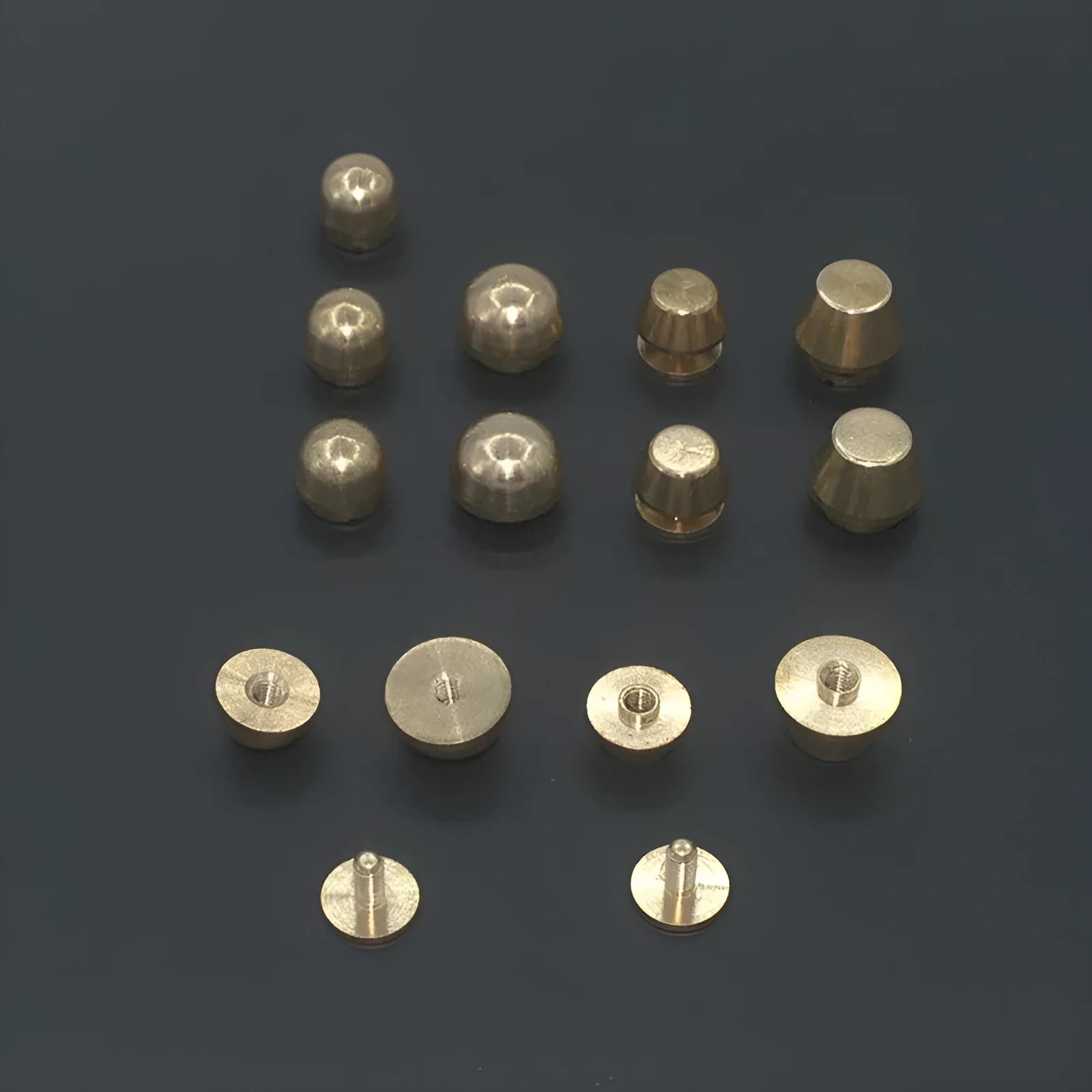 Brass decorative buckle with geometric and round foot nail designs in 10x6mm and 12x7mm sizes.