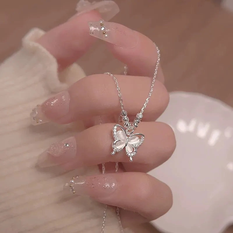 Women's silver butterfly necklace on a cross chain, showing adjustable length and 925 silver pendant.