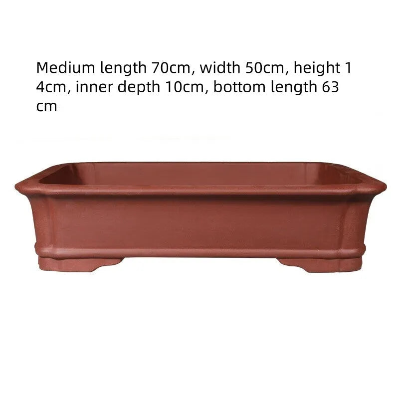 Large rectangular purple clay flowerpot with traditional handmade appearance and drainage holes