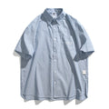 Blue striped short-sleeved overalls shirt with loose cardigan fit on hanger