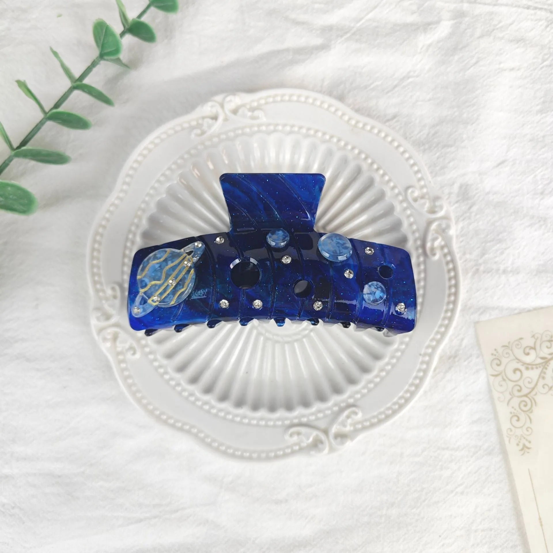 Oversized women's barrette hair clip with a starry sky pattern in sky blue.