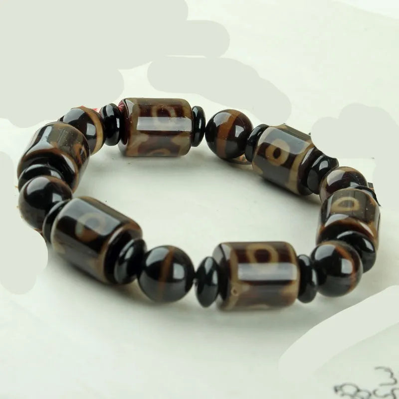Agate Tibetan dzi bead bracelet with three-eye design and polished finish