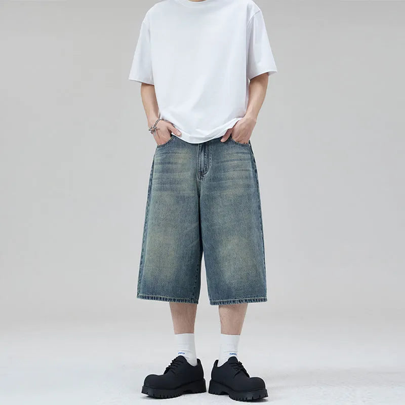 Men's light blue loose-fit cropped denim shorts with a straight leg on a neutral background.