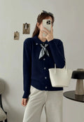 Beige lapel scarf cardigan sweater with long sleeves and splicing details on a model.