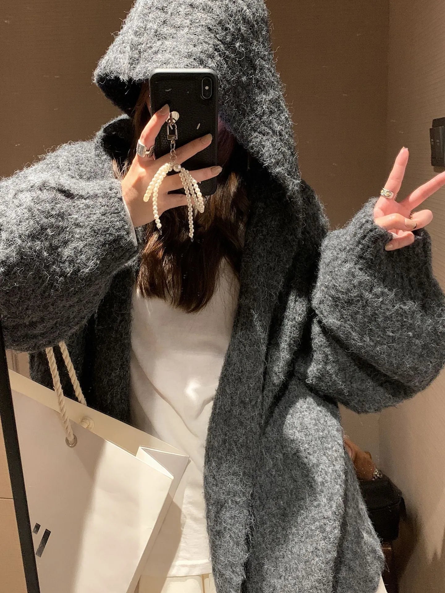 Women's loose fit hooded cardigan in thick acrylic fabric, shown in brown, dark grey, and milky white colour options