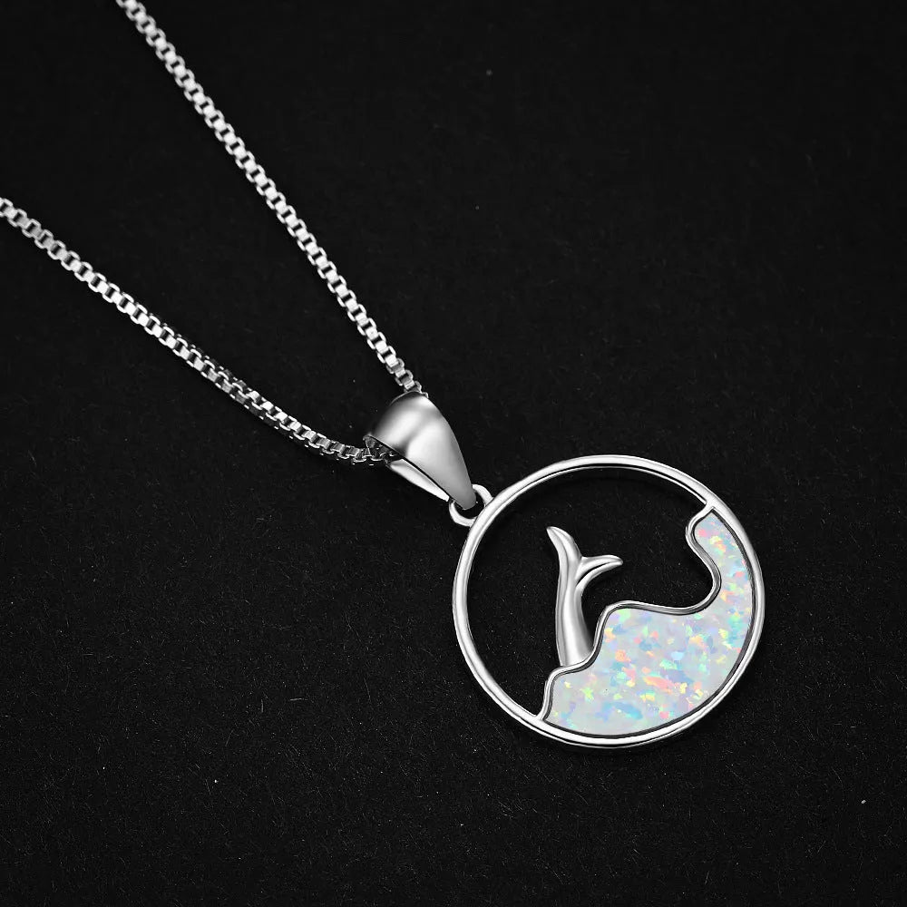 Geometric sea fishtail pendant necklace with a round blue opal stone on a thin chain.