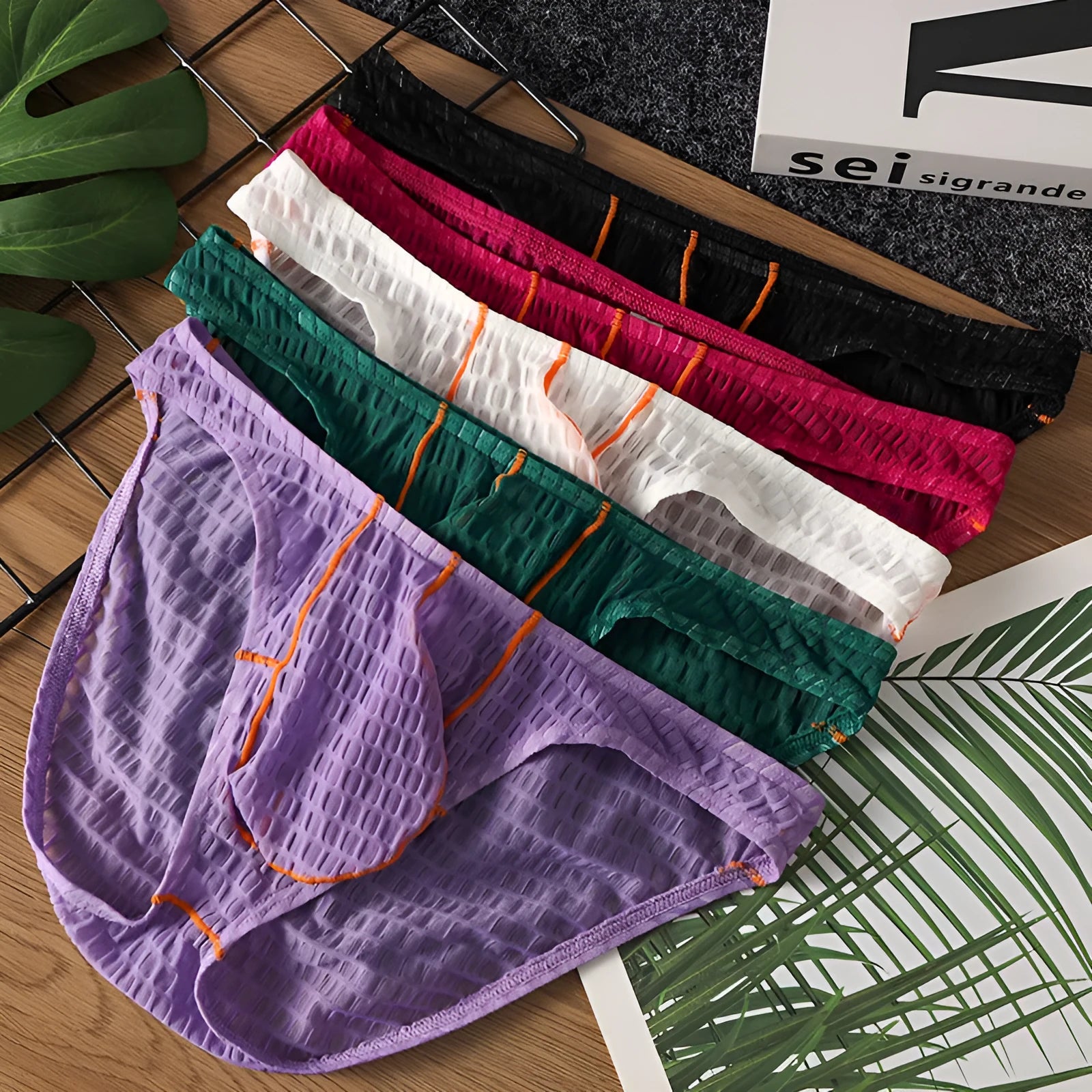Men's ice silk lace low waist briefs in solid colours on a white background