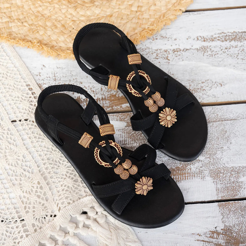 Black women's ethnic style flat beach sandals with beaded weave and rhinestone decorations.