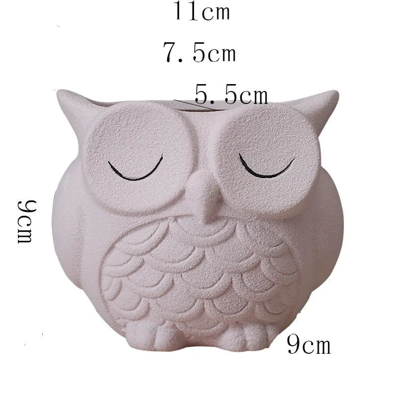 Handmade frosted ceramic flower pot with cartoon owl design, shown in light pink colour.