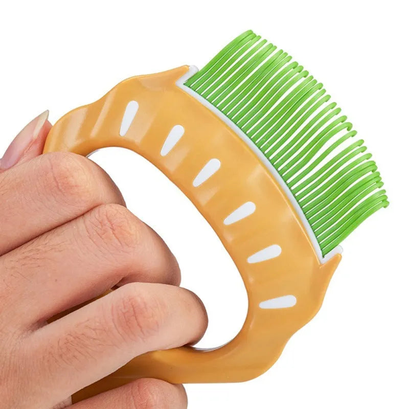 Green shell shaped plastic pet grooming comb with fine bent wire bristles on a white background.