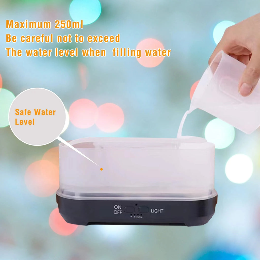 Colourful snowflake pattern aromatherapy humidifier with glowing flame effect and remote control on a desktop.