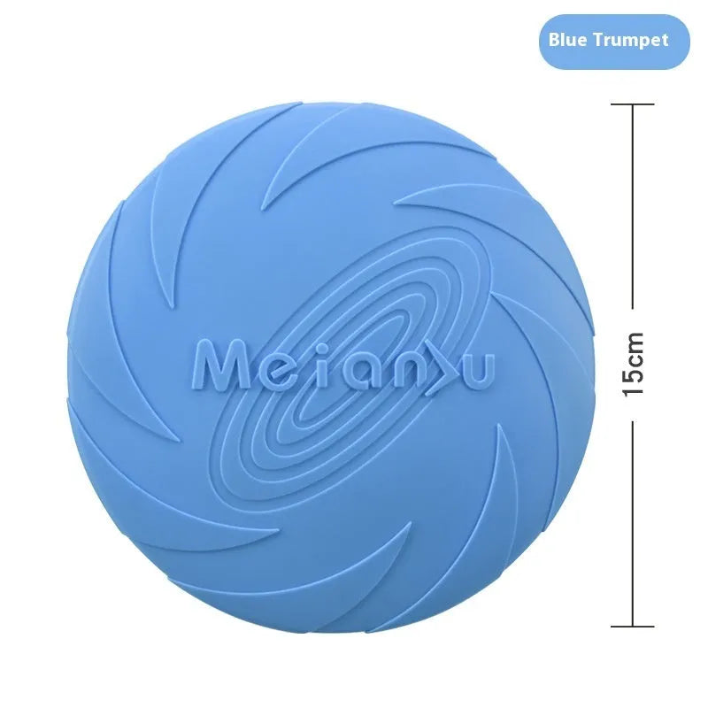 Soft rubber dog frisbee toy in blue, shown on grass for scale.