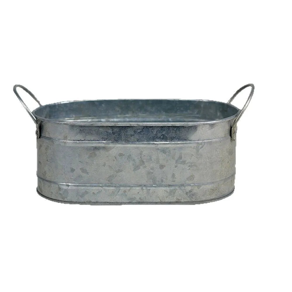 Small iron metal flowerpot for succulents on a wooden desktop.