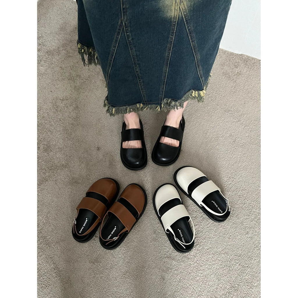 Retro closed toe sandals with raised bottom, ankle strap buckle, and round toe in apricot colour