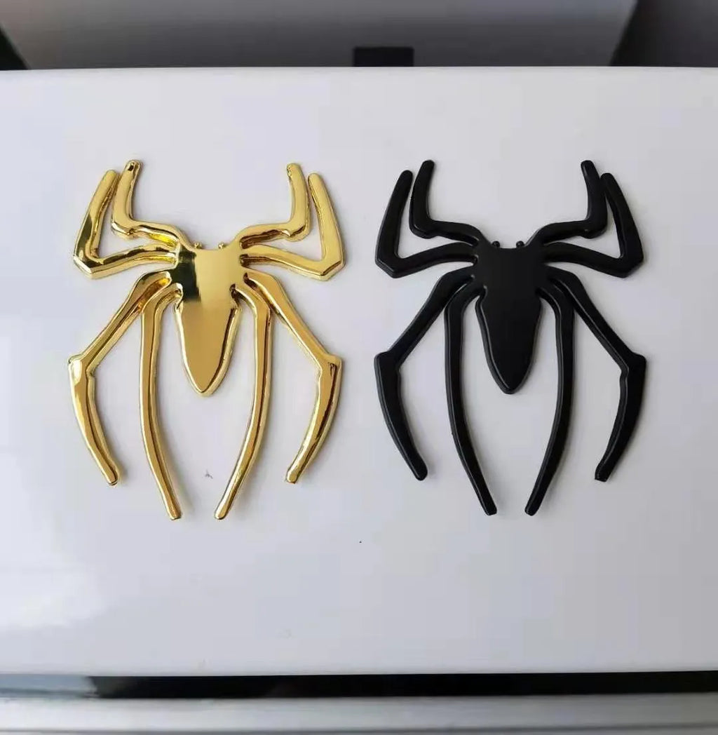 Three-dimensional metal spider sticker in gold colour, measuring 7cm by 5cm.