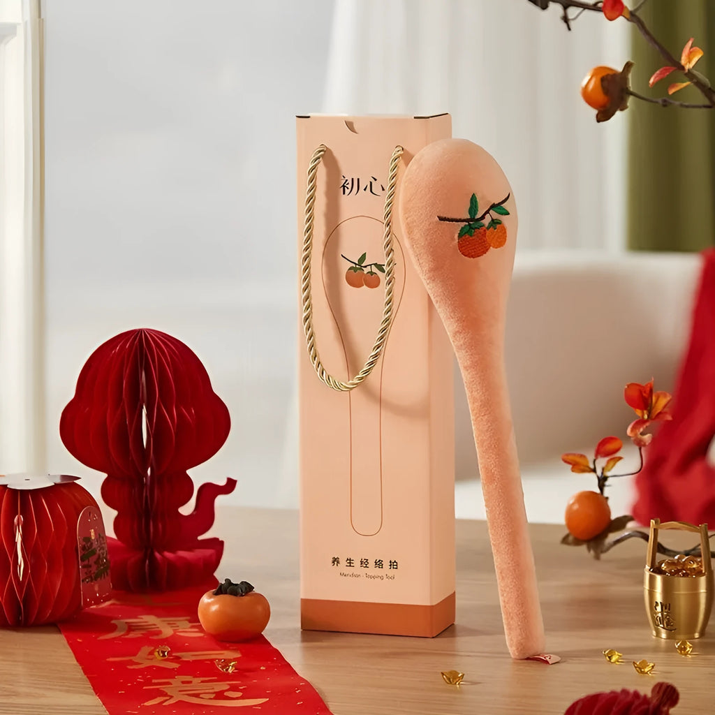 48 cm persimmon coloured back-pounding massage stick with meridian flap design and zipper style construction