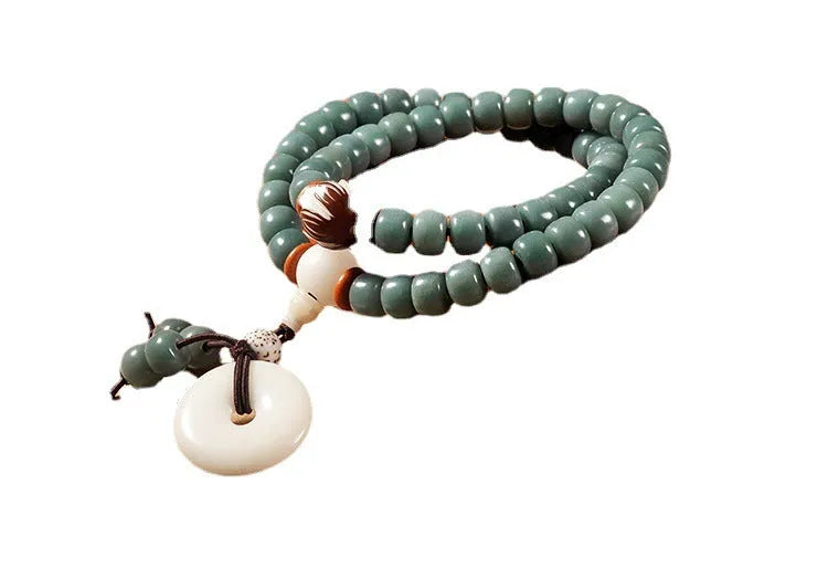White Jade Bodhi Green Sandalwood Bracelet with Bodhi seed beads, lotus charms, and a double ring safety clasp.
