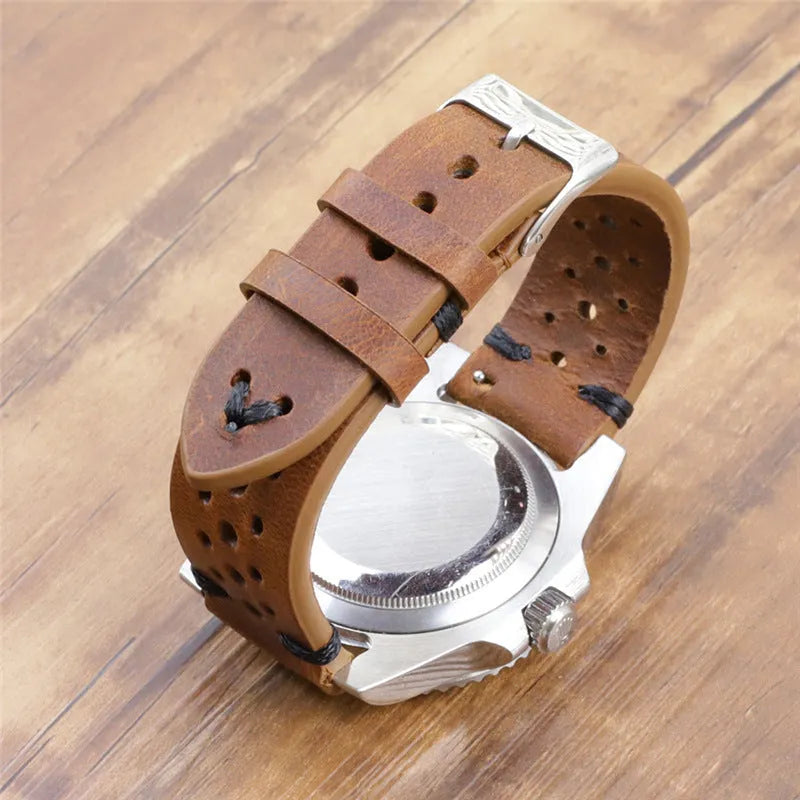 Handmade retro genuine leather watch band in brown with white stitching on a wooden surface