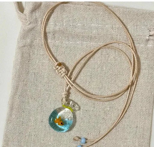 Women's necklace with a coloured glaze skirted joker pendant on a cotton and linen clavicle chain.