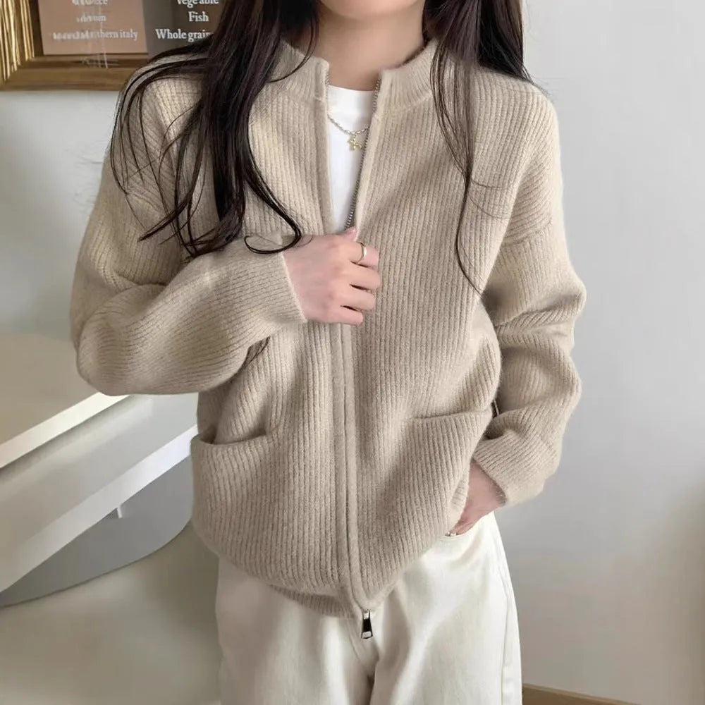 Beige viscose fibre soft wind cardigan coat with long sleeves on a hanger.