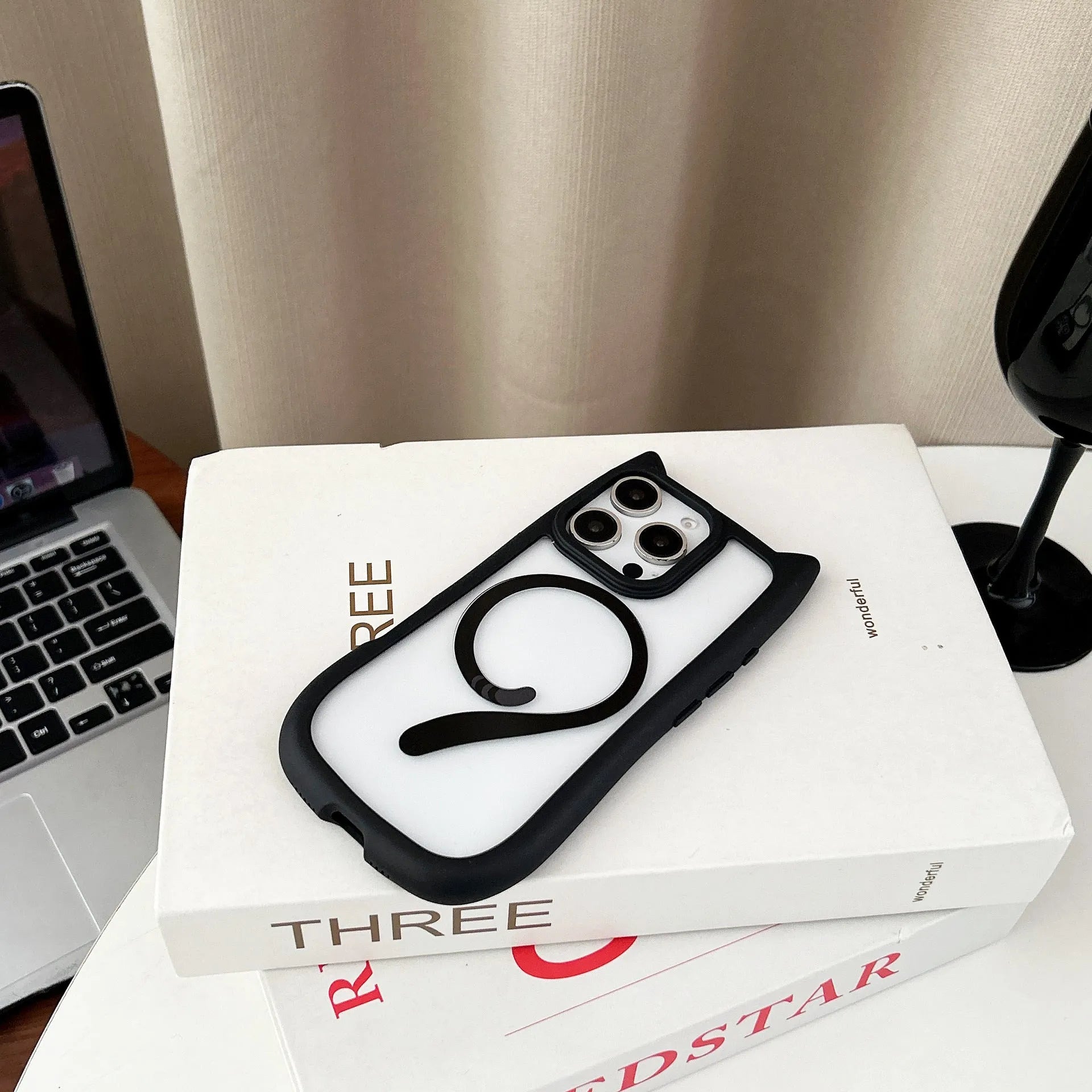 Clear acrylic and TPU two-layer phone case for iPhone 17 models on a table