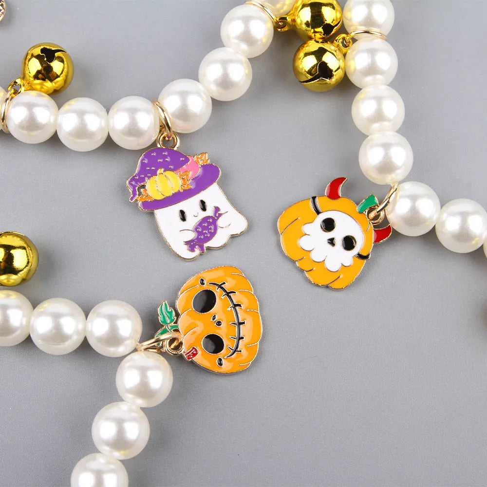 Halloween cat collar with simulated pearls and pumpkin charms in purple ghost, skull, and smiling designs