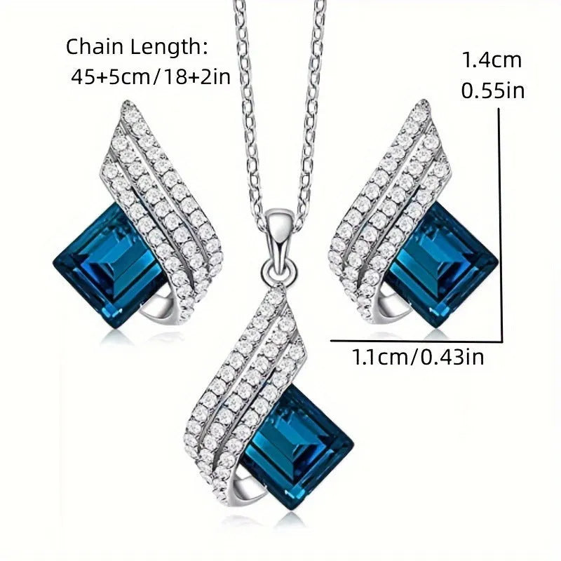 Women's cross chain necklace and earrings set with glass pendant and electroplated finish.
