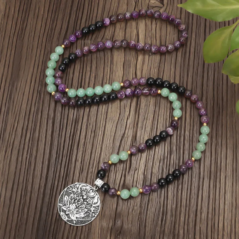 Lotus pendant necklace with stone beads on adjustable ball bead chain alongside matching bracelet