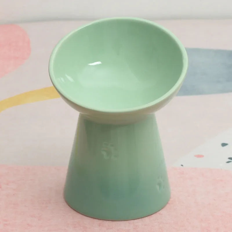 A white ceramic pet bowl with a high foot and raised neck protector to prevent tipping.