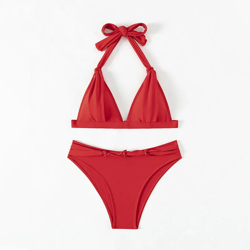 Red women's lace-up halterneck bikini set with split shorts for swimming