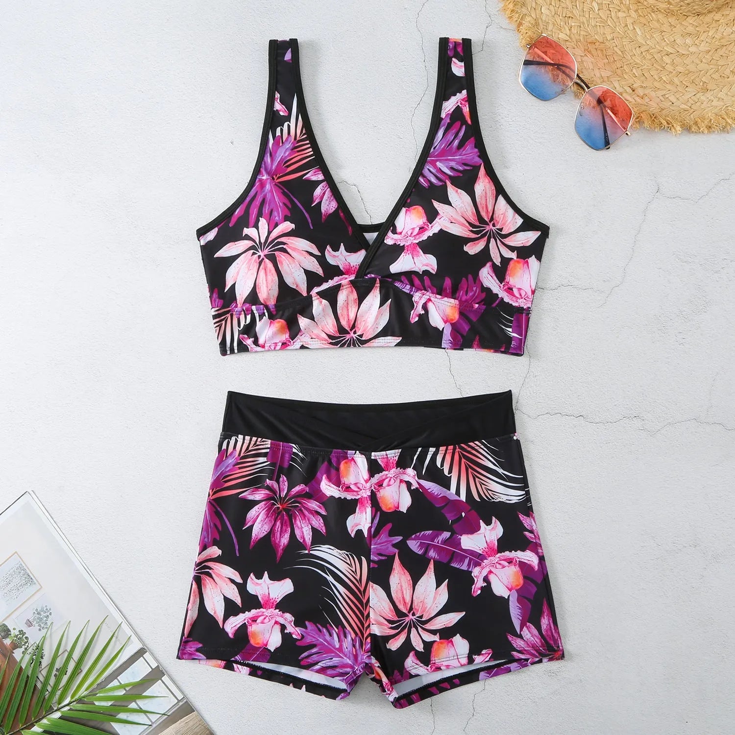 Women's two-piece printed swimsuit with high-neck top and boxer shorts in a multi-colour design.