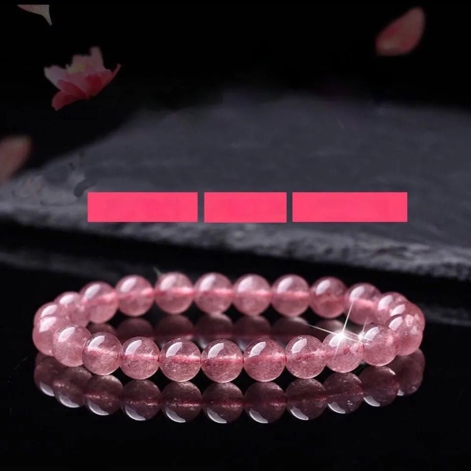 Women's strawberry quartz crystal bracelet with polished beads in three size options.