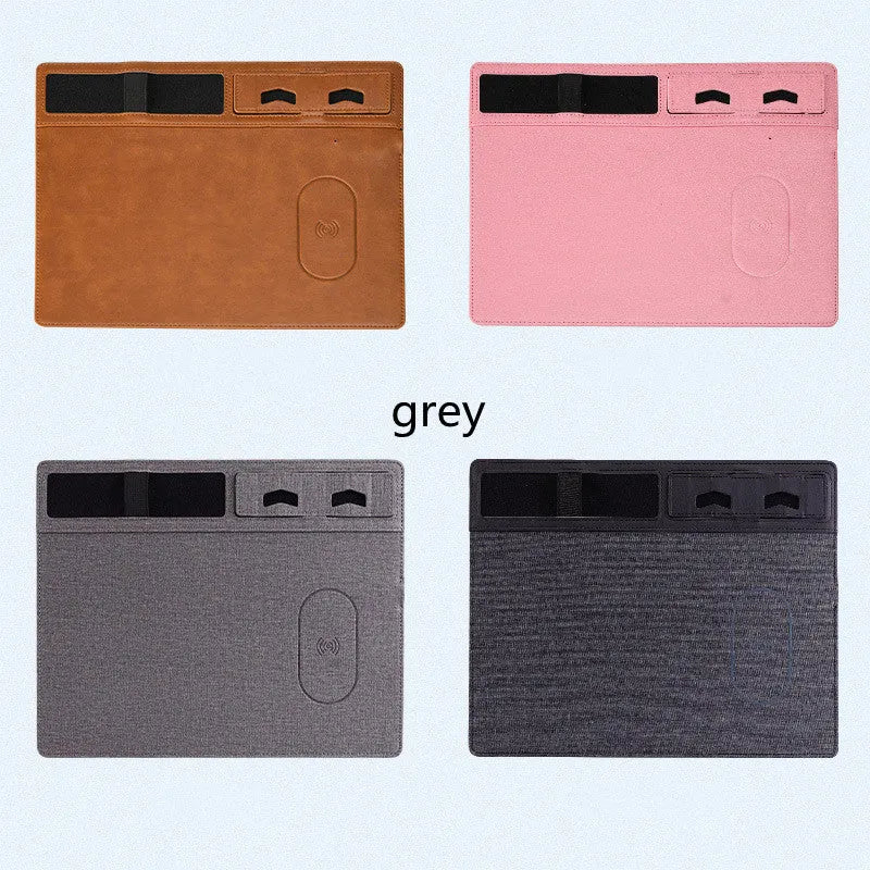Large pink wireless charging mouse pad with integrated mobile phone holder on a desk.