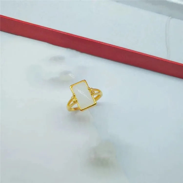 Adjustable brass ring with gold plating and coloured gemstone in national style design