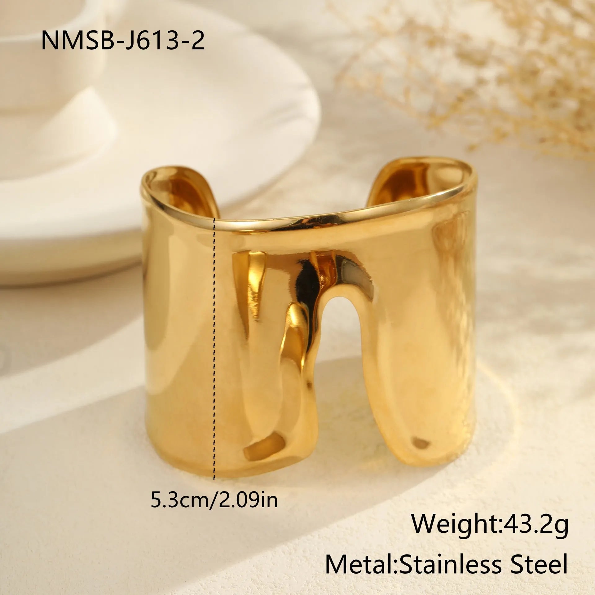 Women's wide fashion bracelet with wave design in gold-plated stainless steel