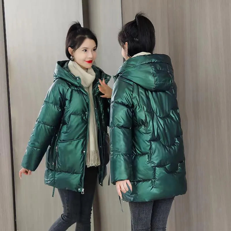 Women's loose fit hooded winter jacket in green colour showing long sleeves and thick insulation