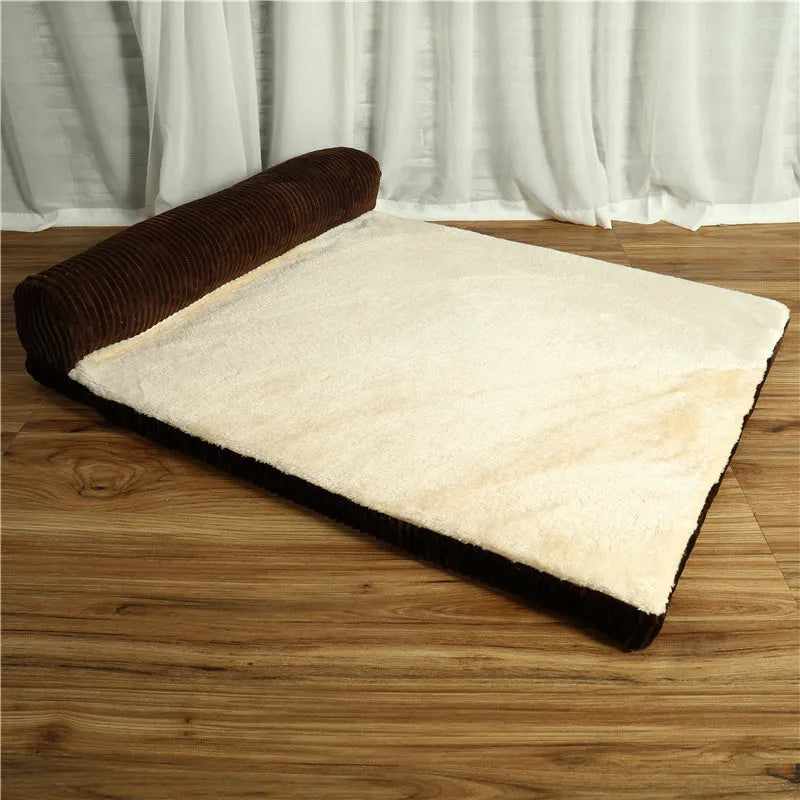Grey corduroy dog sofa bed with raised sides on a wooden floor, showing its non-slip base.