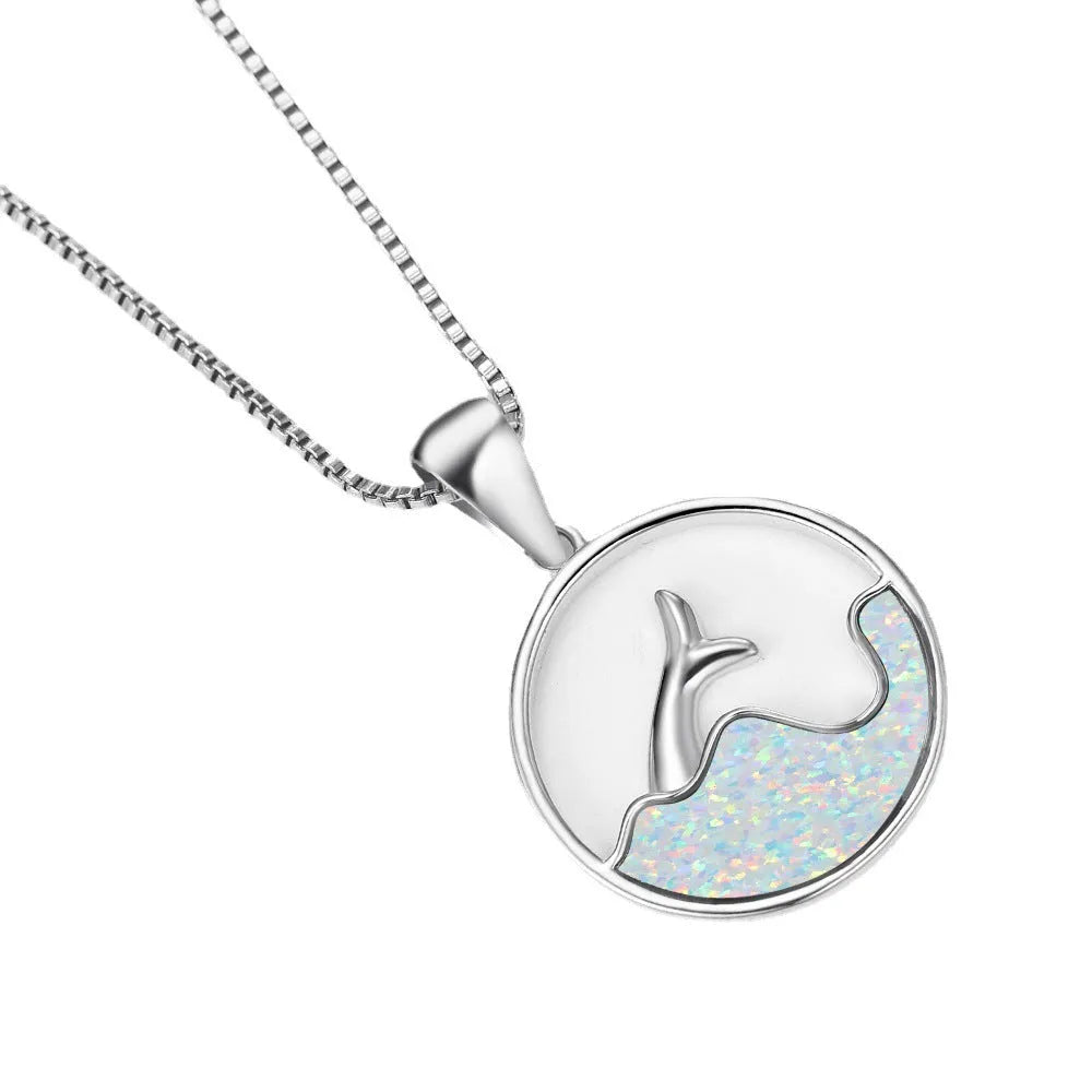 Geometric sea fishtail pendant necklace with a round blue opal stone on a thin chain.